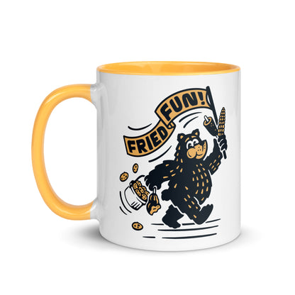 Fair Bear "Fried Fun!" ceramic mug with colorful yellow interior — 11 oz Minnesota fair graphic coffee mug, left view