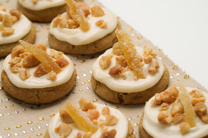 Cookies with white frosting and candied ginger on a decorative surface. Whiskey Gingers cookie, winning cookie of the 2019 Star Tribune Holiday Cookie Contest.
