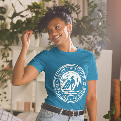 Woman wearing a sapphire blue t-shirt with the Minnesota State Seal in white on the front.